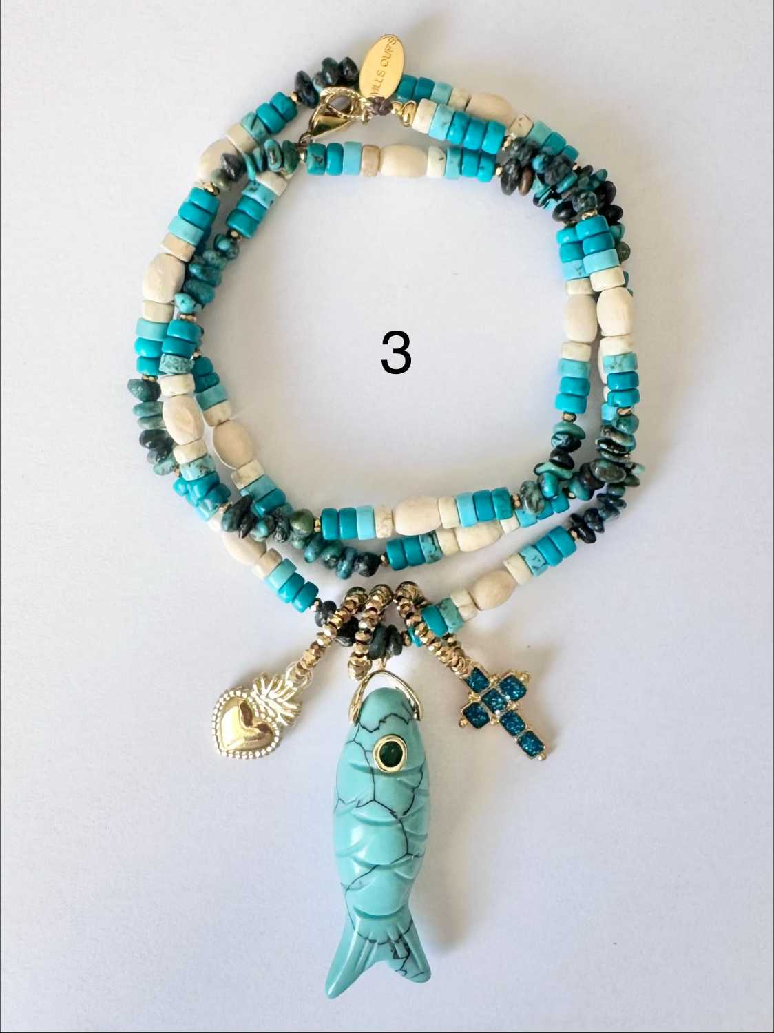 NOMAD-serie03-03-poisson-turquoise-croix-bleue Collier NOMAD série 03 turquoise et ivoire avec poisson en pierre turquoise, croix bleue et cœur doré - création française Mademoiselle Oups